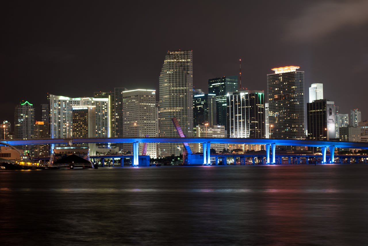 Stunning nighttime view of the illuminated Miami skyline and bridge.